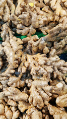 Ginger close-up in the store. Ginger root in the grocery section. Ginger in a plastic box at the food market. Tasty and healthy food. A product for maintaining immunity