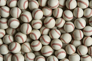 Pile of white baseballs with red seams in a random arrangement