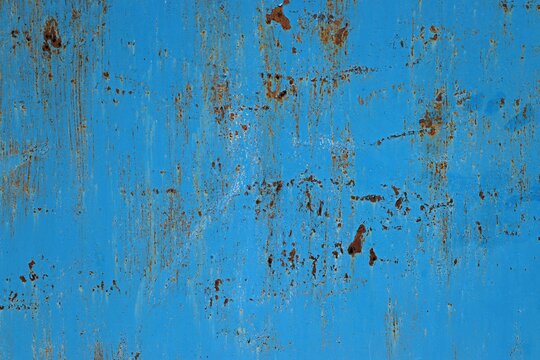 Background, texture metal surface covered with blue paint with rust showing through