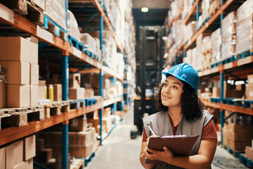 Female warehouse worker inspecting inventory with clipboard