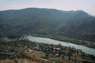 Scenic river valley with mountain slopes and a winding river. Aerial view of the confluence of the...