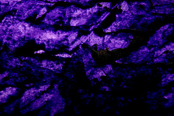 
dark background with bright purple stains