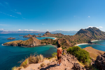 Young man tourist enjoying the beautiful landscape at Padar island in Komodo National Park, Indonesia © Kittiphan