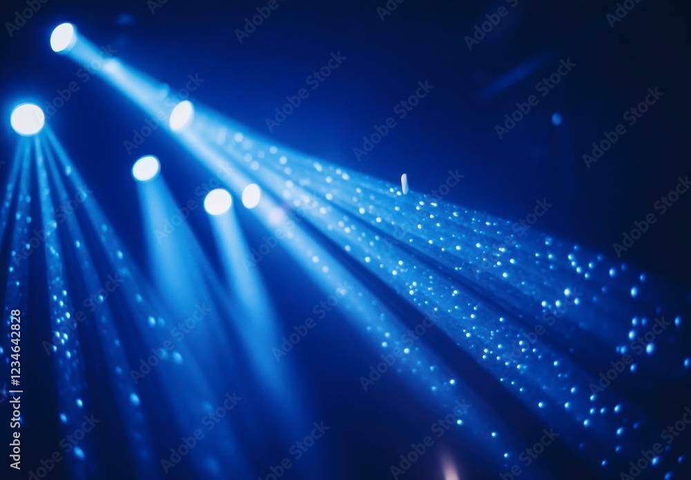 Poster dynamic blue stage lighting illuminates a dark background with sparkling particles, creating an ener