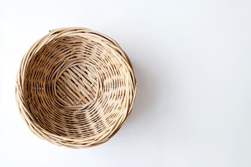 Fototapeta premium An overhead view of an empty wicker basket placed on a white surface
