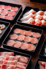 Fresh Meat and Seafood Variety on Black Trays for Culinary Use