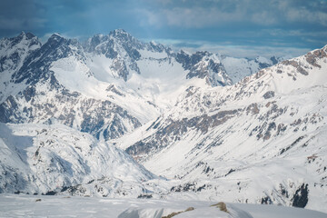 Naklejka premium Majestic snow-covered mountain peaks in the Ski Arlberg skiing arena in Austria around Sankt Christoph am Arlberg displays the best conditions for the skiing slopes