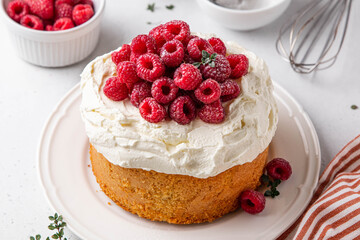 Homemade classic victoria vanilla sponge cake or biscuit or pie decorated with whipped cream and fresh strawberries on top on a light background. Summer dessert. Copy space. Selective focus.