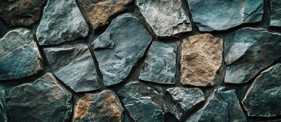 Textured stone wall background with various sizes of irregular stones in grey and brown hues, ideal for architectural and design applications, Copy Space
