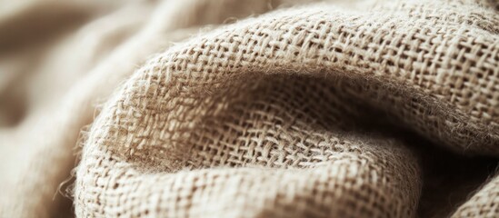 Close-up view of textured burlap fabric with natural fibers and folds Copy Space