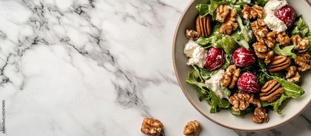 Aufkleber fresh salad with walnuts and raspberries in a bowl on a marble countertop with copy space for text