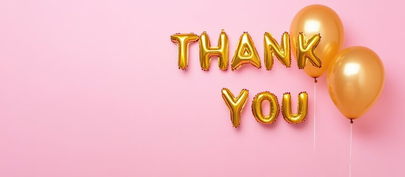Gold foil "Thank You" balloons on a pink background with Copy Space for text addition - Powered by Adobe