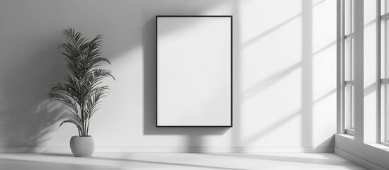 Minimalist interior with empty frame on wall and indoor plant in modern setting featuring natural light and shadows Copy Space