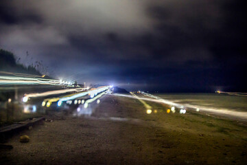 Night seascape in summer with lots of glare from lanterns	
