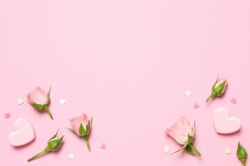 Beautiful composition with pink roses and hearts on color background