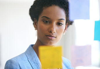 Woman, thinking and office for sticky notes plan, brainstorming and company development. Female...