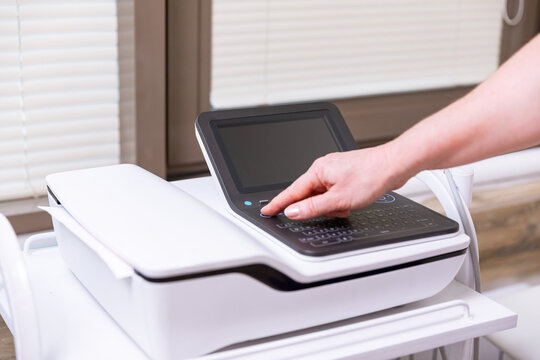 Cardiologist with electrocardiogram equipment is making cardiogram test of patient who is attached with vacuum sensors to the machine. Healthcare concept