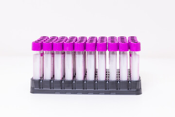 A rack of vacuum venipuncture test tubes for blood samples isolated on a while background. Medical...