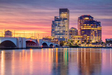 West Palm Beach, Florida, USA. Cityscape image of West Palm Beach, Florida with reflection of the city skyline in the water at beautiful sunset.