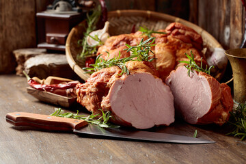 Smoked ham on an old wooden table.