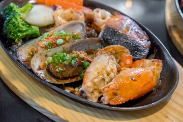 Grilled seafood served on plate including shrimp, mussels, and salmon