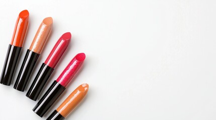 Five Lipstick Tubes in Red, Orange, and Nude Shades on White Background