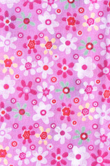 Pink floral fabric background showing colorful flowers and circles