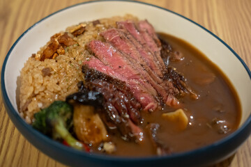 Fatbeef fried rice with sirloin steak served on plate