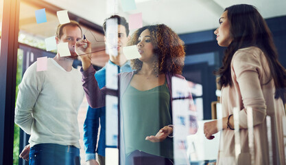 People, glass and writing in office for creativity, brainstorming or project management. Design team, woman leader or reflection in creative agency for planning, workflow update or timeline on window