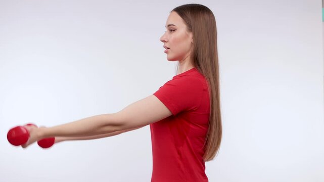Young beautiful girl in a red T-shirt shows wet armpits after doing sports. Treatment of hyperhidrosis.