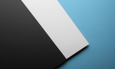 Abstract black, white, and blue paper backdrop.