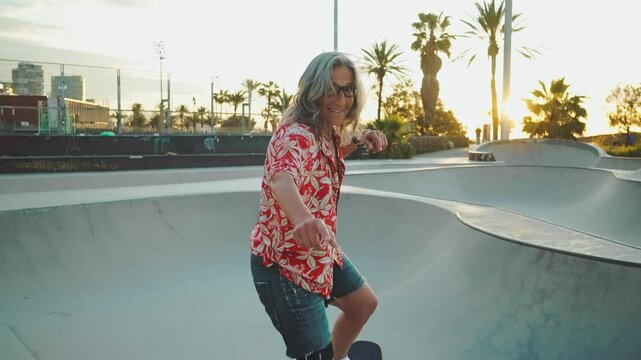 A graceful and assured senior woman with silver hair skateboarding in the open air.	