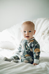 Baby, portrait and happy with cute child in nursery, relax with growth and early childhood development. Smile, face and little kid, adorable newborn and infant sitting up with calm in bedroom