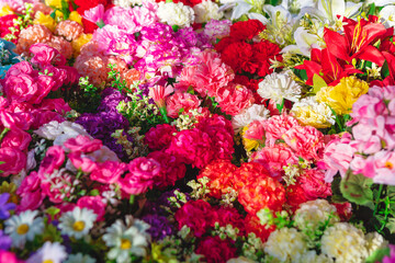 Collection of colorful natural flowers. Flowers are densely packed together, creating a visually striking and colorful display that highlights the beauty and variety of different floral species
