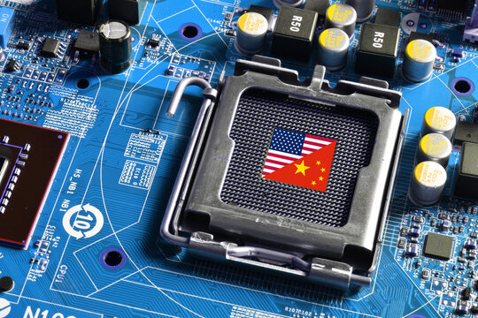 Flag of the Republic of China and the United States on the core of CPU socket of a pc motherboard. Concept for world supremacy in microchip and semiconductor manufacturing.