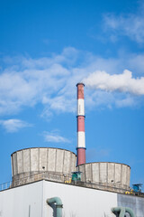 Greenhouse gas emissions into the atmosphere. Smoking power plant chimney, carbon dioxide released...