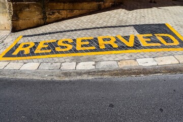Reserved parking spot sign painted on a paved street