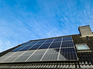 Solar panels providing sustainable energy on a rooftop under a blue sky