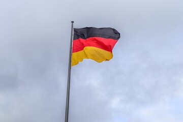 German flag waving on a cloudy sky background