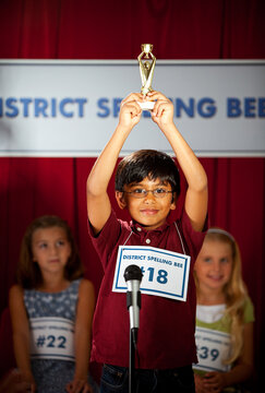 Spelling: Boy Excited to Win Trophy