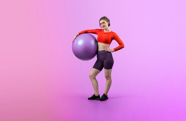 Full body length gaiety shot athletic and sporty young woman with fitness exercising ball in standing posture on isolated background. Healthy active and body care lifestyle.