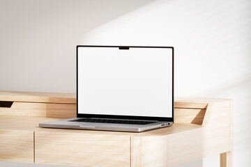 Opened laptop with blank white screen on the wooden desk © Yevhen