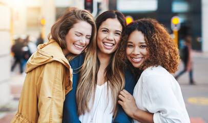 Women, laughing and hug in city portrait, holiday travel and bonding together for friendship. People, diversity and trip on street of urban town for connection, funny conversation and girlfriends