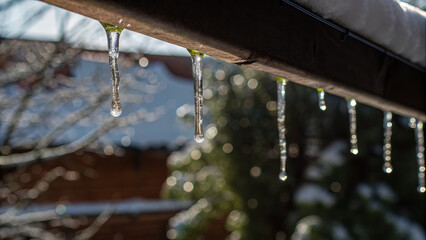 Melting icicles with refracted sunlight and tiny rainbows