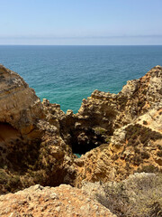 A breathtaking coastal landscape with rugged cliffs, rocky formations, and deep crevices.