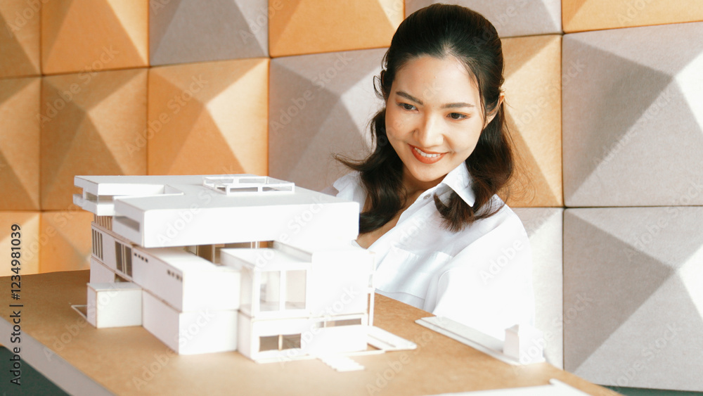 Aufkleber skilled attractive architect engineer holds architect model while checking mistake point carefully. 