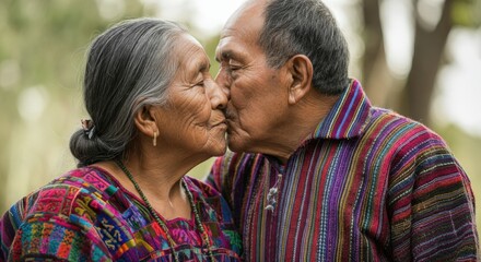 Fototapeta premium Elderly hispanic couple in traditional colorful clothing sharing a tender moment