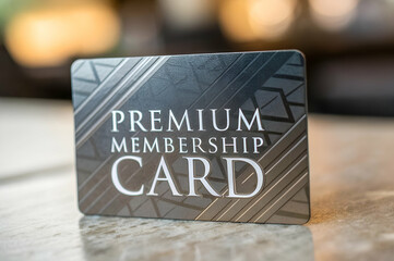 Customer Experience, A sleek black premium membership card with embossed text, showcasing exclusivity and sophistication against a blurred background.