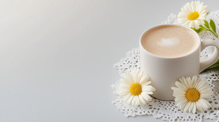 White coffee cup with a flower on top of a white cloth. Minimalistic background.