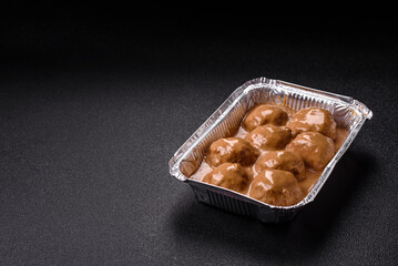 Meatballs with salt and spices in creamy caramel sauce